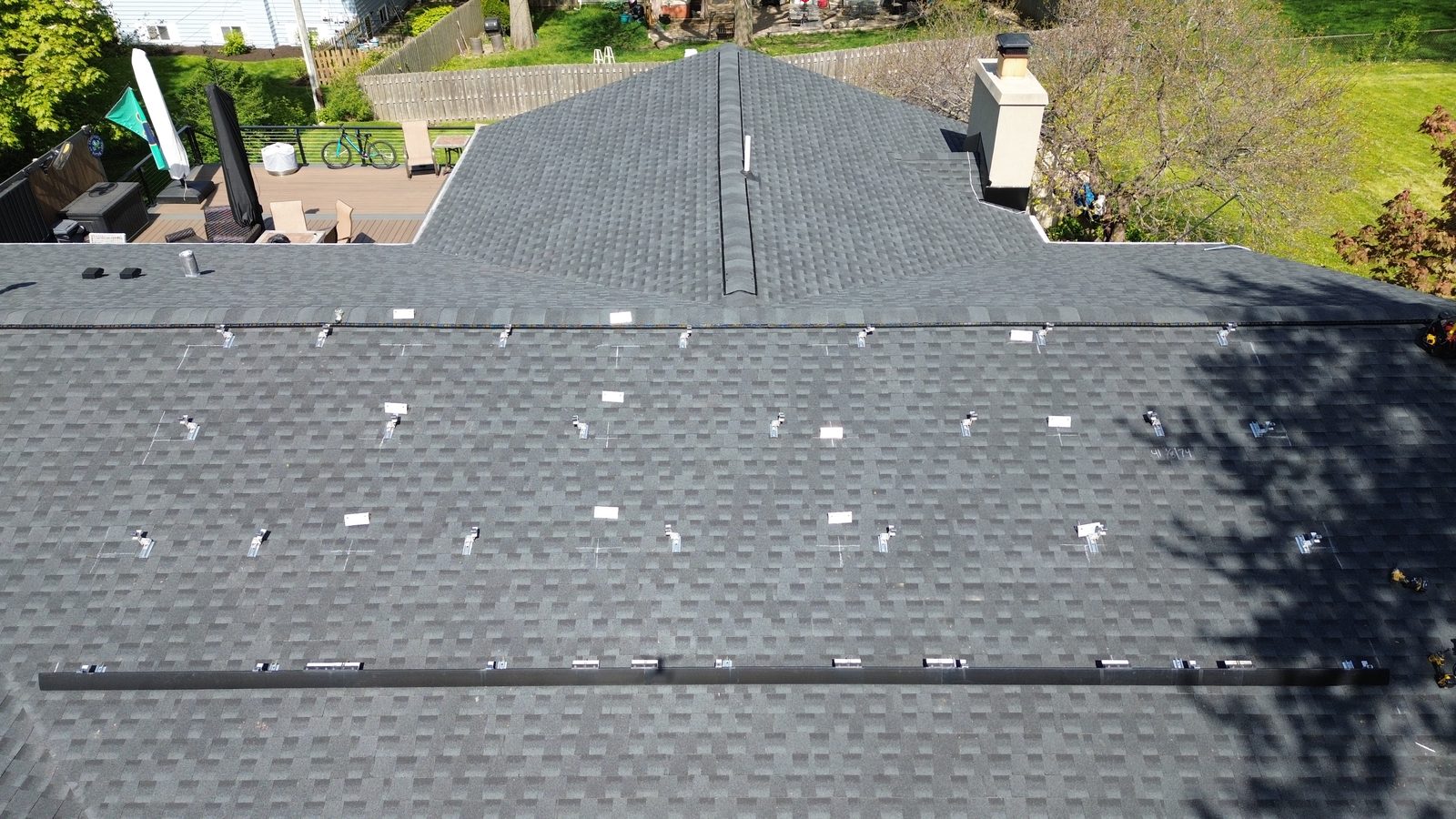 Removal and reinstall in Palatine, IL — bare roof with mounting brackets after solar panels were removed