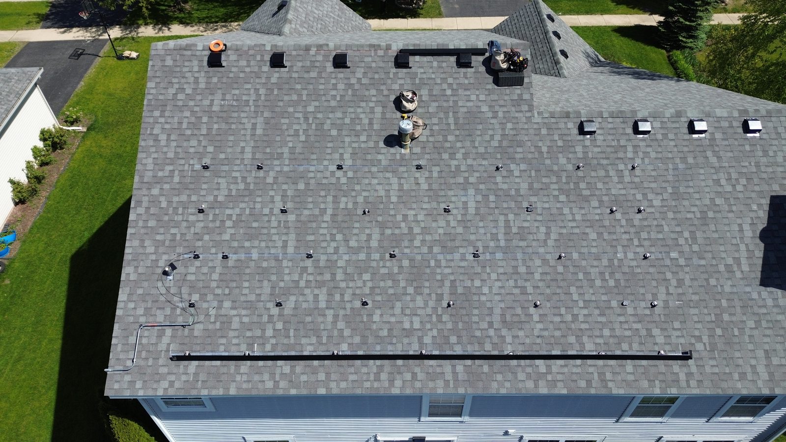 Removal and reinstall in Naperville, IL — racking rails installed on a cleared roof, ready for panels