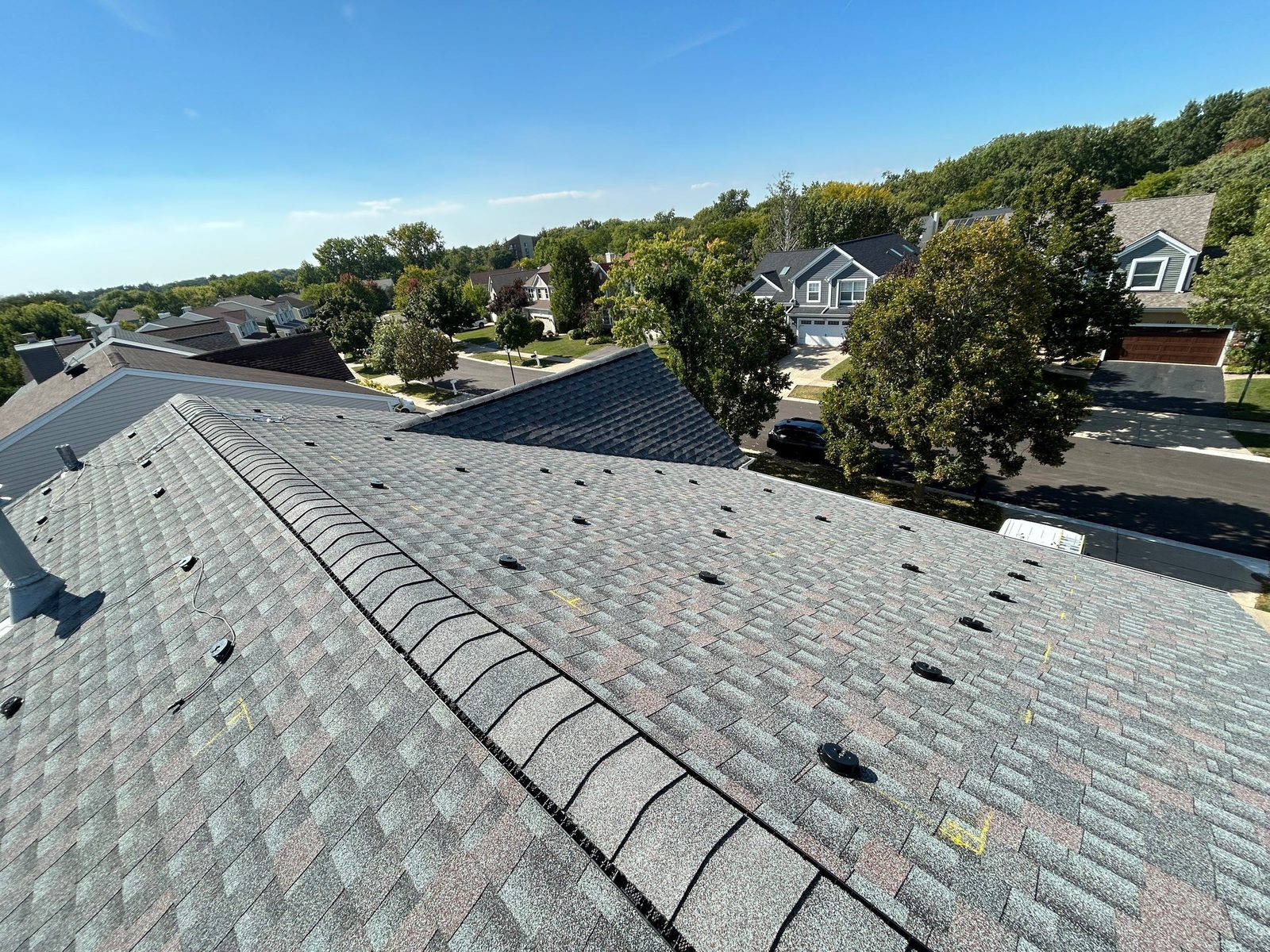 Removal and reinstall in Elk Grove Village, IL — bare roof with mounting brackets after solar panels were removed