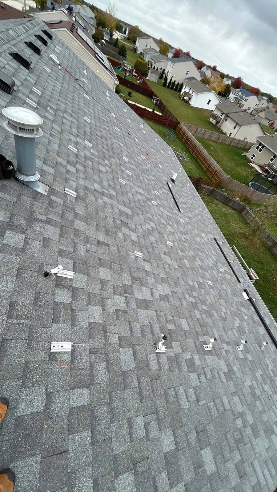 Removal and reinstall in Crystal Lake, IL — racking rails installed on a cleared roof, ready for panels